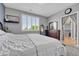 Comfortable bedroom features natural light from a large window and an adjacent walk-in closet at 19771 E Wesley Pl, Aurora, CO 80013