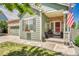 Inviting front porch with a patriotic display, brick accents, and seating area at 19771 E Wesley Pl, Aurora, CO 80013