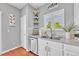 Kitchen featuring white cabinets, stainless dishwasher and sink, beautiful backsplash, and corner shelves at 19771 E Wesley Pl, Aurora, CO 80013