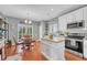 Eat-in kitchen with stainless steel appliances, a center island and white cabinetry at 19771 E Wesley Pl, Aurora, CO 80013