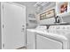 Laundry room features new washer and dryer, shelving, and door to the rest of the house at 19771 E Wesley Pl, Aurora, CO 80013