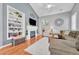 Cozy living room with vaulted ceilings, fireplace, built-in shelving and hardwood floors at 19771 E Wesley Pl, Aurora, CO 80013