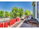 Stone patio featuring outdoor seating and mature trees with a clear blue sky above at 19771 E Wesley Pl, Aurora, CO 80013