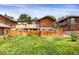 The backyard boasts a lush lawn, a wood fence, and is perfect for relaxation or entertaining guests at 1255 S Dillon Way, Aurora, CO 80012