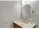 Bright bathroom with single sink vanity with granite countertop, and oval mirror at 1255 S Dillon Way, Aurora, CO 80012