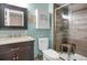 Modern bathroom with walk-in shower, vanity with storage, and decorative mirror and artwork at 1255 S Dillon Way, Aurora, CO 80012