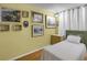 Comfortable bedroom with bright yellow walls, wood floors, and a cozy twin bed at 1255 S Dillon Way, Aurora, CO 80012