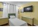Cozy bedroom with bright yellow walls, wood floors, and a comfortable twin bed at 1255 S Dillon Way, Aurora, CO 80012