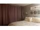Cozy bedroom featuring soft lighting, decorative mirrors, and a comfortable-looking bed at 1255 S Dillon Way, Aurora, CO 80012