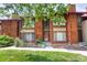 Exterior shot of the property featuring a well-manicured lawn and mature shade trees at 1255 S Dillon Way, Aurora, CO 80012