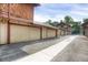 Row of garages featuring neutral paint and red trim, with a clean, paved driveway, providing ample parking at 1255 S Dillon Way, Aurora, CO 80012