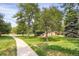 Manicured grounds featuring lush trees and walking paths, perfect for peaceful strolls and enjoying nature at 1255 S Dillon Way, Aurora, CO 80012
