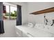 Bright laundry room with appliances next to window, offering natural light at 1255 S Dillon Way, Aurora, CO 80012
