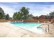 Sparkling community pool surrounded by lounge chairs and a wooden fence, perfect for summer relaxation at 1255 S Dillon Way, Aurora, CO 80012
