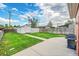 Large backyard featuring lush grass, mature trees, storage shed and a spacious concrete patio at 2204 S Acoma St, Denver, CO 80223