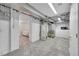 Unfinished basement area showcasing the mechanicals and access to the bedroom at 2204 S Acoma St, Denver, CO 80223