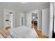 Bright bedroom featuring hardwood floors, white trim, and access to other rooms at 2204 S Acoma St, Denver, CO 80223