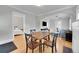 Dining room with hardwood floors, archway details, and an open layout to the living room at 2204 S Acoma St, Denver, CO 80223