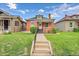 Charming brick home with a well-manicured lawn and inviting walkway to the front door at 2204 S Acoma St, Denver, CO 80223