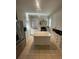 Well-lit kitchen boasts stainless appliances, island, and ample counter space, ideal for meal preparation at 2204 S Acoma St, Denver, CO 80223