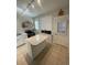 Bright kitchen featuring white cabinetry, stainless appliances, and a central island, perfect for cooking at 2204 S Acoma St, Denver, CO 80223