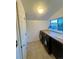 Functional laundry room featuring modern washer and dryer set, complemented by a wooden countertop at 2204 S Acoma St, Denver, CO 80223