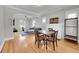 Open-concept living and dining area with hardwood floors and a comfortable seating arrangement at 2204 S Acoma St, Denver, CO 80223