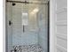 Modern bathroom shower with glass doors, tiled walls, and stylish fixtures at 2204 S Acoma St, Denver, CO 80223