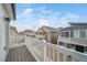 View from balcony overlooking the neighborhood with similar style houses and blue skies at 46526 Avery Ln, Bennett, CO 80102