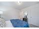 Bedroom with a blue bedspread and a storage cabinet in the corner of the room at 46526 Avery Ln, Bennett, CO 80102
