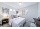 Comfortable bedroom with neutral tones, featuring a window and bedside table with decorations at 46526 Avery Ln, Bennett, CO 80102
