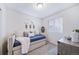 Cozy bedroom featuring a daybed with plush pillows, window with blinds, and stylish accents at 46526 Avery Ln, Bennett, CO 80102