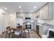 Open concept living area includes a dining table, modern kitchen, and additional seating with lots of space at 46526 Avery Ln, Bennett, CO 80102