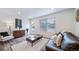 Comfortable living room with a plush rug, neutral colors, and ample natural light at 46526 Avery Ln, Bennett, CO 80102