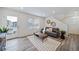 Bright living room with a door to the outside, showcasing a stylish rug and decor at 46526 Avery Ln, Bennett, CO 80102