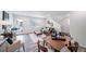 An open-concept living space with a dining table seamlessly connects the kitchen and a cozy seating area at 46526 Avery Ln, Bennett, CO 80102