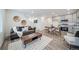Cozy living room and dining area with modern furnishings and stainless steel kitchen appliances at 46526 Avery Ln, Bennett, CO 80102