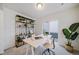 Bright office space features a shelving unit, work space, and sliding glass door to a patio at 46526 Avery Ln, Bennett, CO 80102