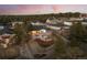 An aerial view of a home with backyard, patio, and hot tub surrounded by other beautiful homes and luscious pine trees at 6001 Powell Rds, Parker, CO 80134