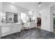 Bright bathroom with double vanities, sleek fixtures, and access to a well-organized walk-in closet at 6001 Powell Rds, Parker, CO 80134