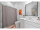 Bright bathroom with a shower featuring a patterned curtain and modern fixtures at 6001 Powell Rds, Parker, CO 80134