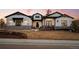 Charming two-story home featuring white siding, stone accents, a well-manicured lawn, and a welcoming front porch at 6001 Powell Rds, Parker, CO 80134