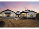 Charming two-story home featuring white siding, stone accents, a well-manicured lawn, and a welcoming front porch at 6001 Powell Rds, Parker, CO 80134