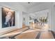 Bright foyer featuring light hardwood floors, large horse art piece, and views into the dining area at 6001 Powell Rd, Parker, CO 80134