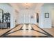 Bright open foyer with unique wood floors and a decorative chandelier at 6001 Powell Rd, Parker, CO 80134