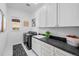 Efficient laundry room with modern appliances, ample counter space, and stylish storage solutions at 6001 Powell Rds, Parker, CO 80134