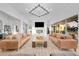 Bright living room with large chandelier, gas fireplace, and sliding glass doors to the patio at 6001 Powell Rd, Parker, CO 80134