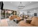 Open living room with couches, hardwood floors, and views to the patio at 6001 Powell Rd, Parker, CO 80134