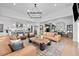 Open-concept living area flows into a bright kitchen with hardwood floors and stylish furnishings at 6001 Powell Rds, Parker, CO 80134