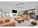 Bright living room featuring modern furniture, a fireplace, a mounted tv, and large windows with backyard views at 6001 Powell Rds, Parker, CO 80134